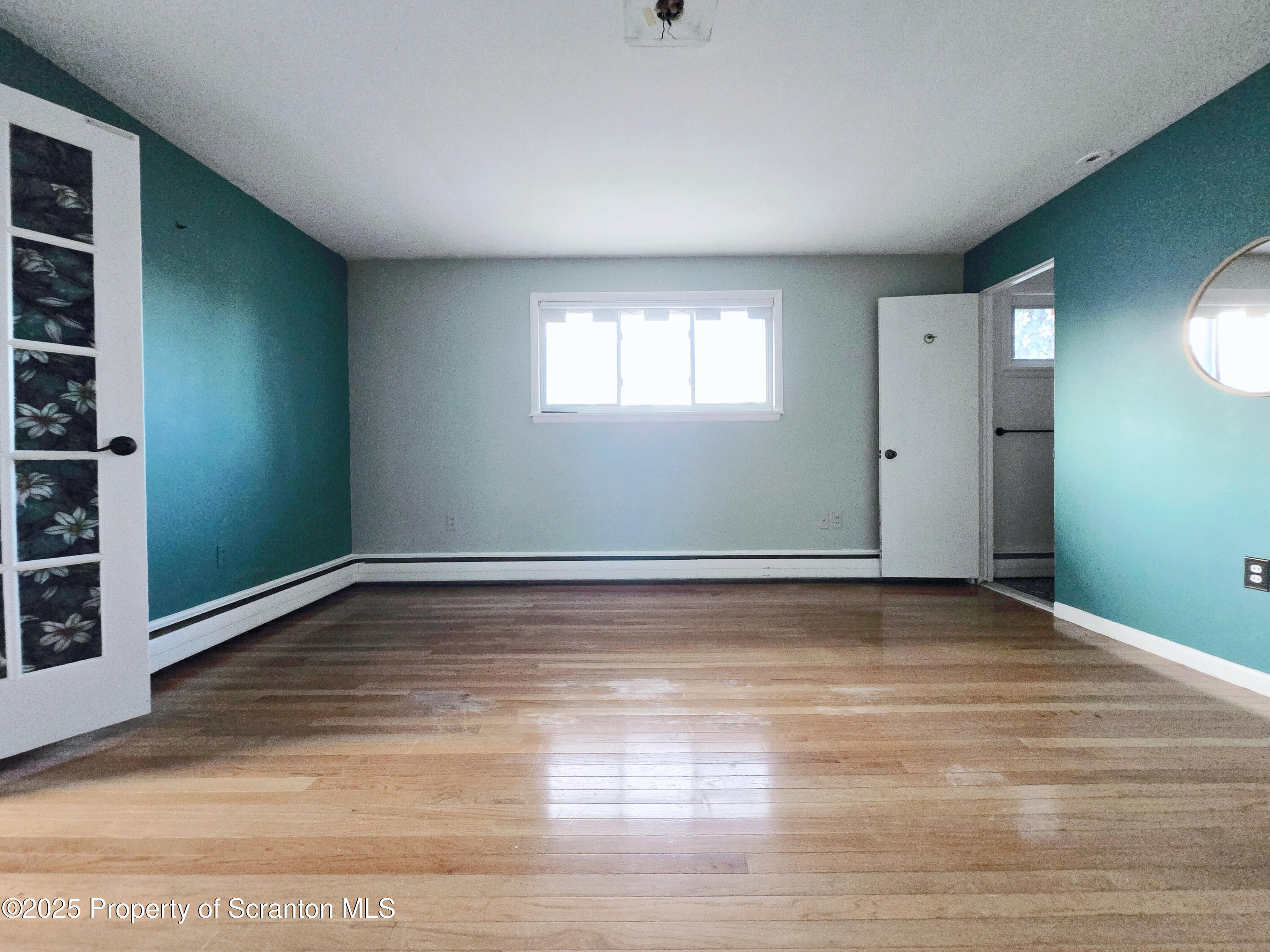 215 Lake Scranton Road Scranton, PA 18505 - Photo 19 of 31 a view of an empty room with wooden floor and a window