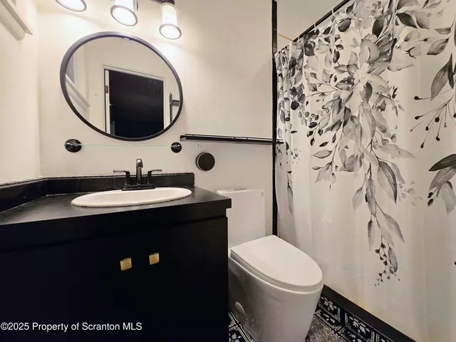 a white toilet sitting next to a bathroom sink