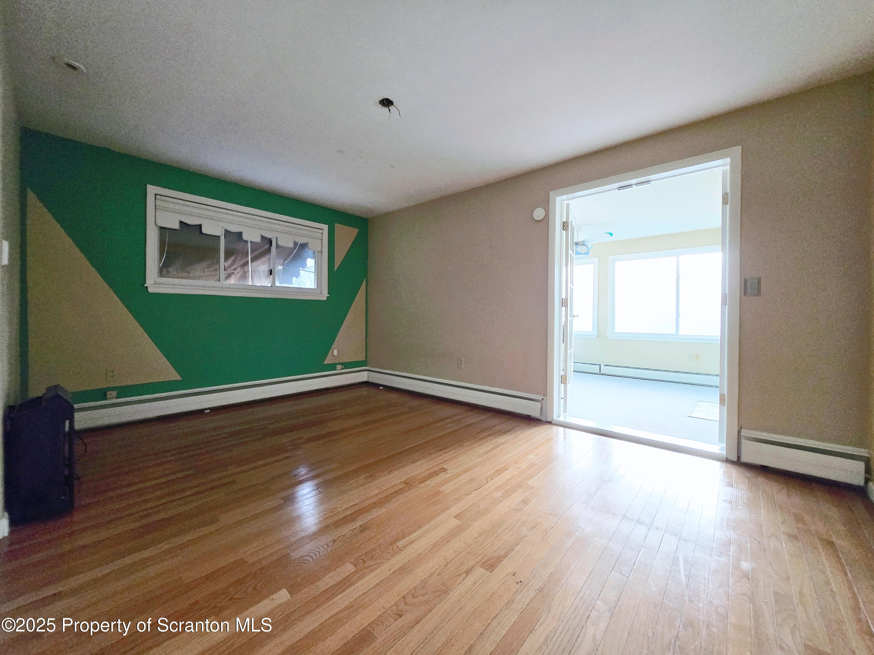 215 Lake Scranton Road Scranton, PA 18505 - Photo 22 of 31 an empty room with wooden floor and windows