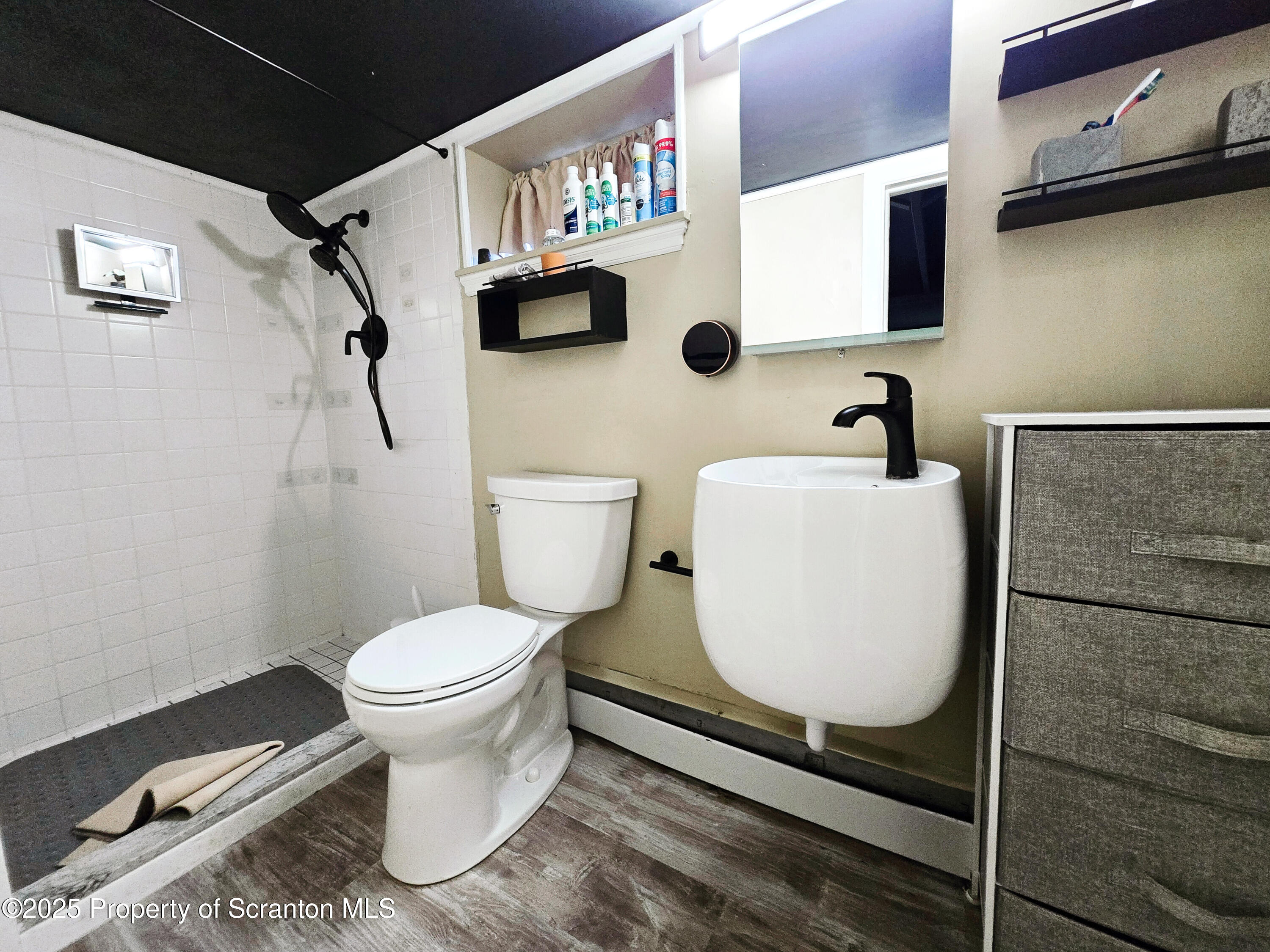 215 Lake Scranton Road Scranton, PA 18505 - Photo 29 of 31 a white toilet sitting next to a bathroom sink