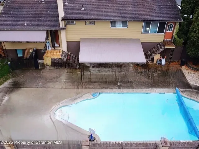 an aerial view of residential building and trees around