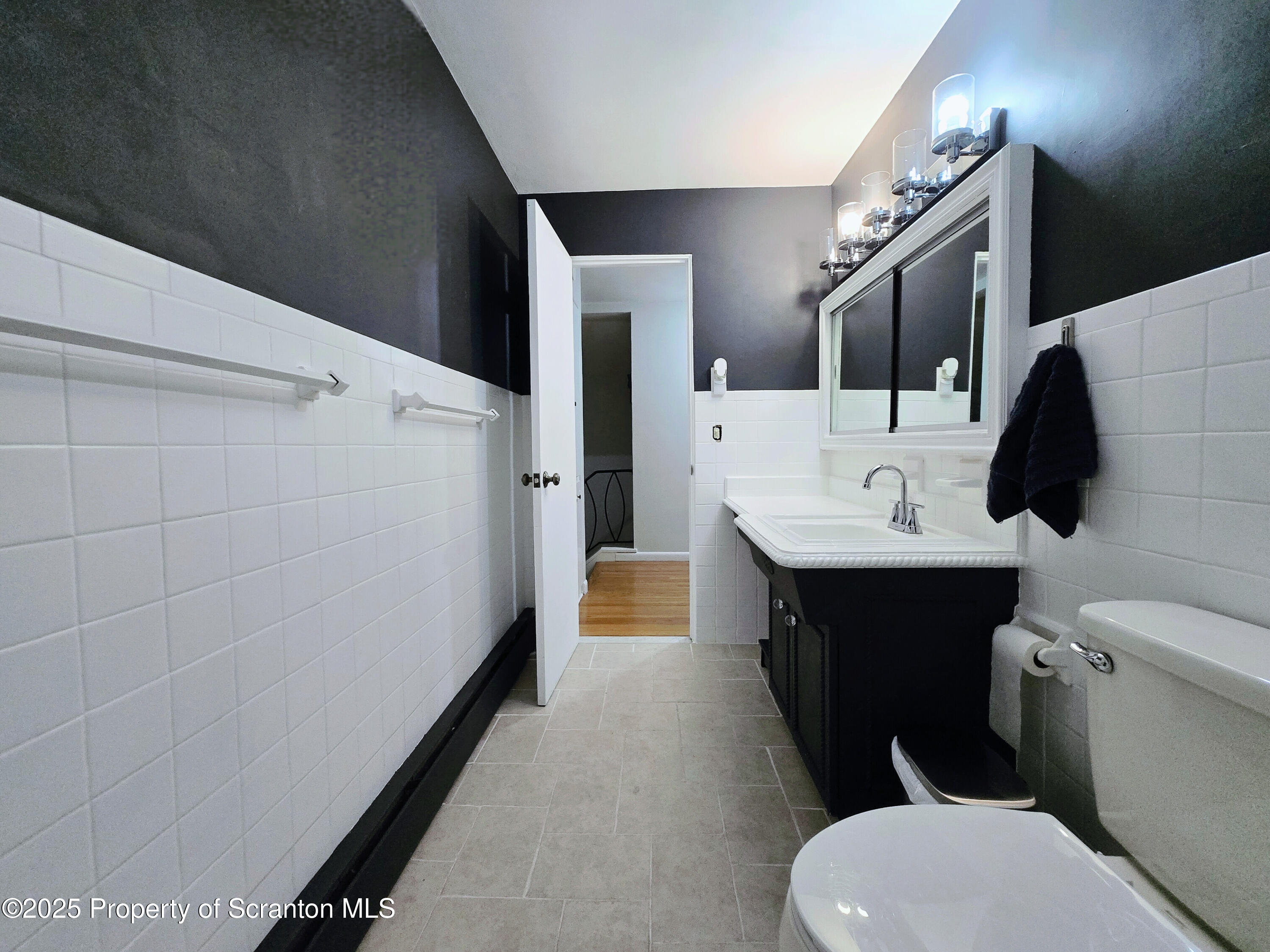 215 Lake Scranton Road Scranton, PA 18505 - Photo 9 of 25 a bathroom with a sink a toilet and mirror