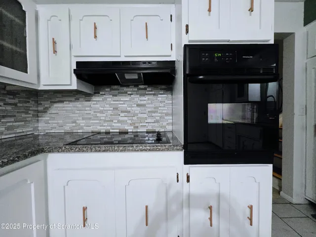 a living room with furniture and a hard wood floor
