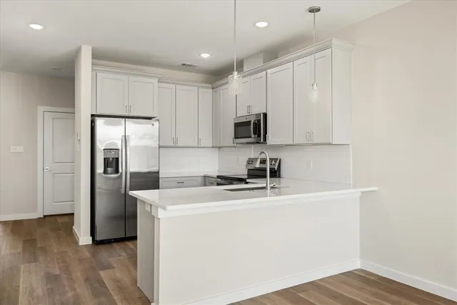 a kitchen with stainless steel appliances white cabinets and a stove