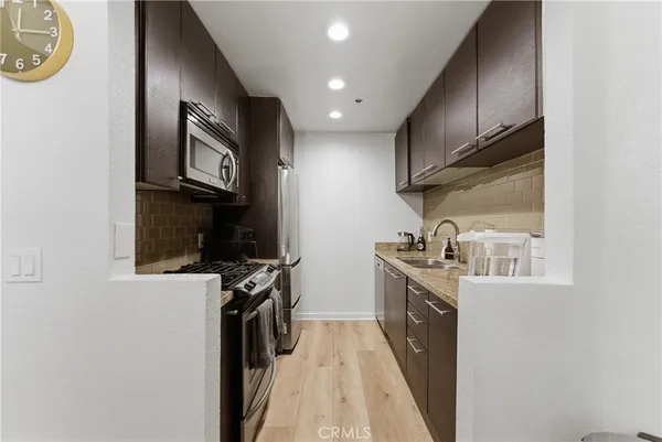 a kitchen with stainless steel appliances granite countertop a stove and a sink