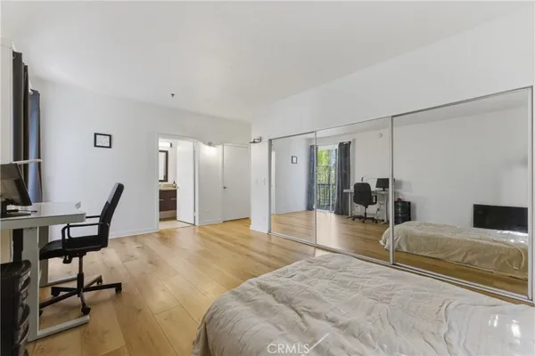 a bedroom with a bed a desk and chair