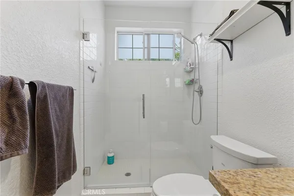 a bathroom with a shower and toilet