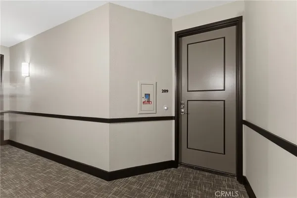 a view of kitchen with refrigerator and white cabinets