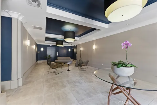 a living room with furniture and flowers