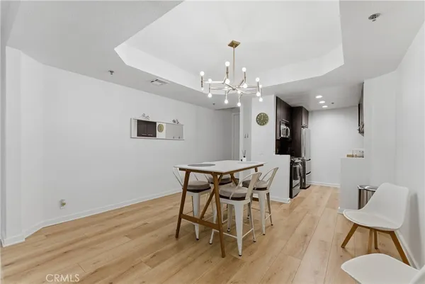 a view of a dining room with furniture and chandelier