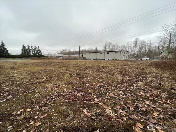a view of a field with trees in the background