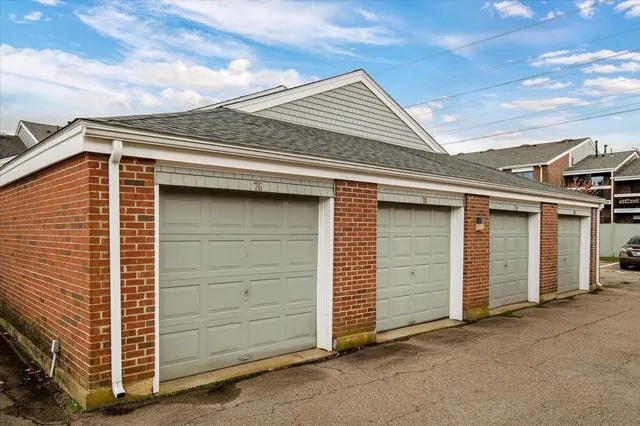 an aerial view of a house with a garden and lake view