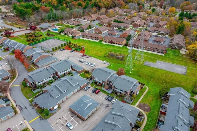 an aerial view of a house with a garden and swimming pool