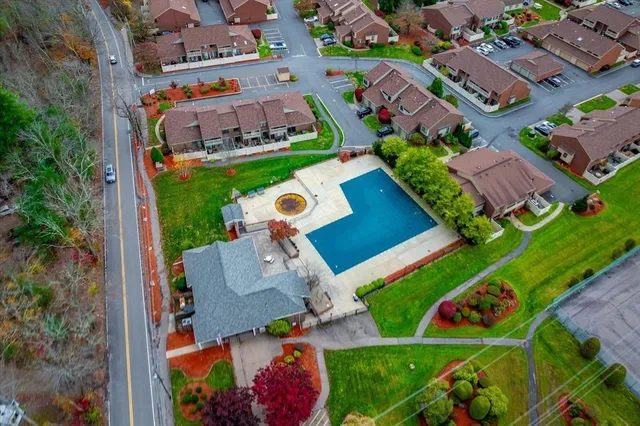 an aerial view of a house with a garden and trees