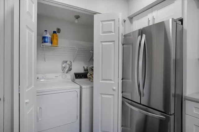 a view of a refrigerator and utility room