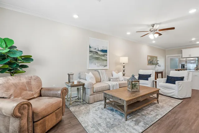 a living room with furniture a rug and a chandelier