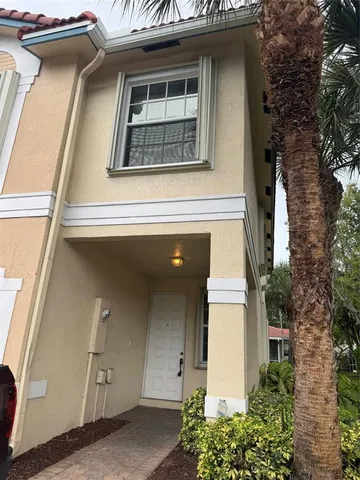 a view of a livingroom with wooden floor and a staircase