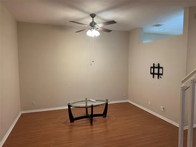 a view of a room with wooden floor and white cabinet
