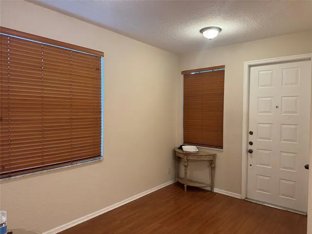 a view of hallway with stairs and wooden floor