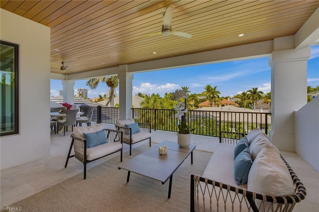 529 Neapolitan Way Naples, FL 34103 - Photo 24 of 26 a balcony with furniture