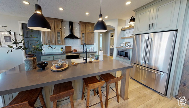 1547 North 1350 E Street, Unit 2 Mapleton, UT 84664 - Photo 4 of 18 Kitchen with appliances with stainless steel finishes, wall chimney range hood, open shelves, tasteful backsplash, and recessed lighting