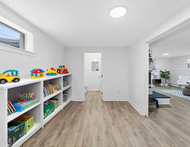 a view of room with toys and wooden floor