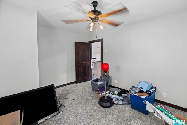 a bedroom with furniture and a chandelier fan