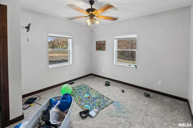 a view of room with window hardwood floor and a ceiling fan