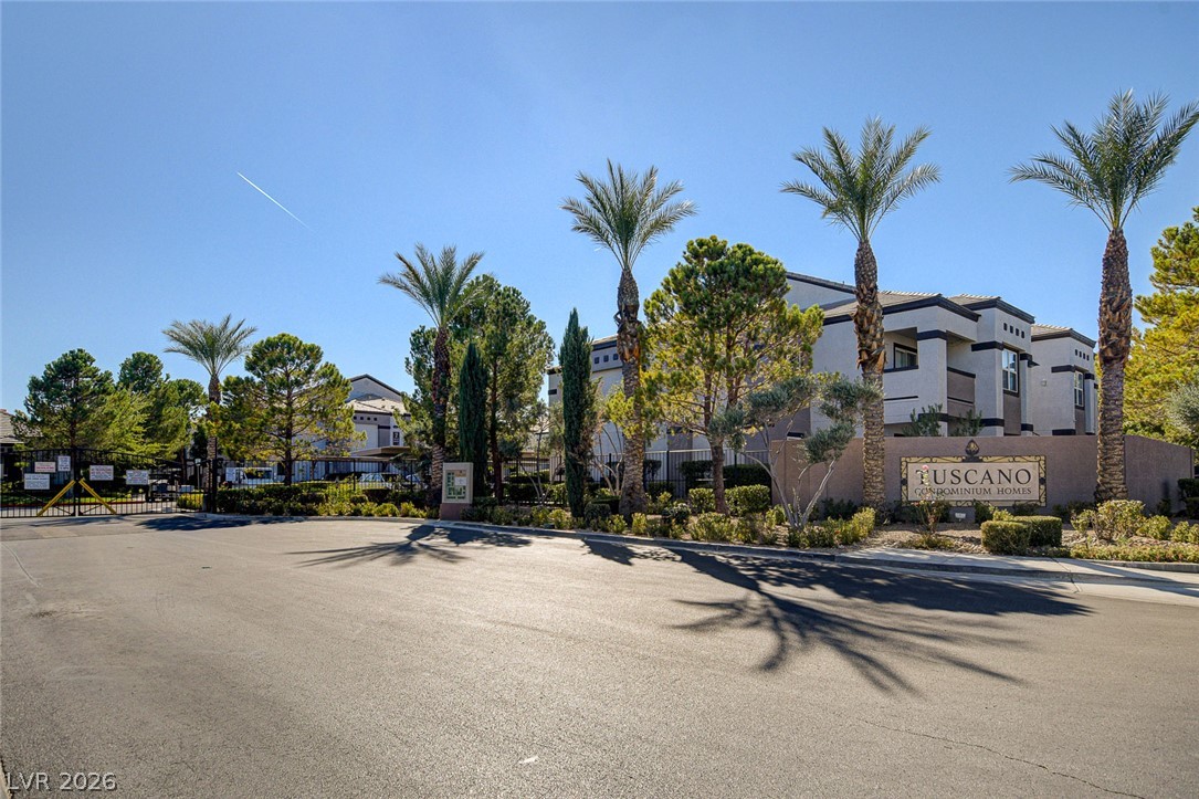 7255 West Sunset Road, Unit 2005 Las Vegas, NV 89113 - Photo 2 of 27 Secure community entrance framed by mature palm trees and meticulously maintained landscaping.