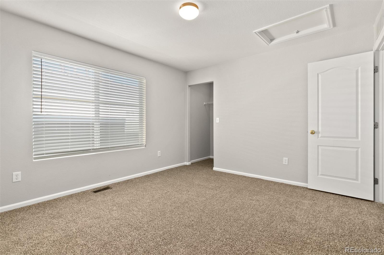 2562 Coach House Loop Castle Rock, CO 80109 - Photo 13 of 20 a view of an empty room with a window and closet area