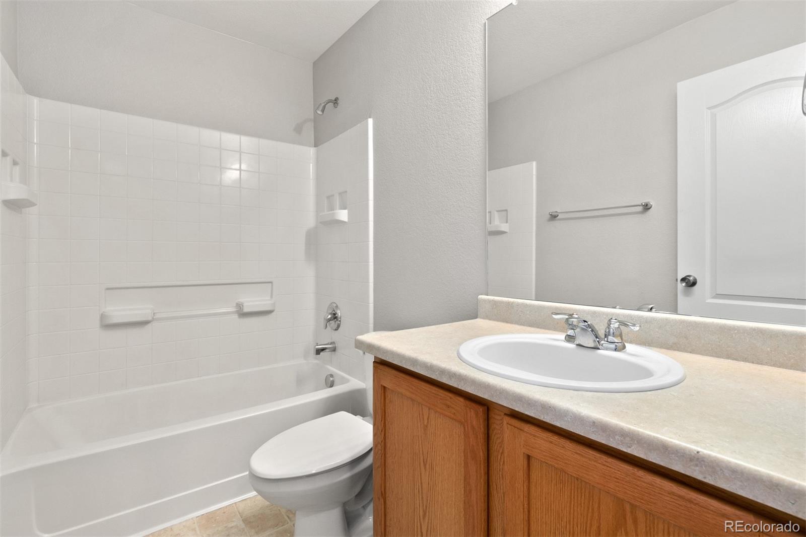 2562 Coach House Loop Castle Rock, CO 80109 - Photo 15 of 20 a bathroom with a sink a toilet and a large mirror