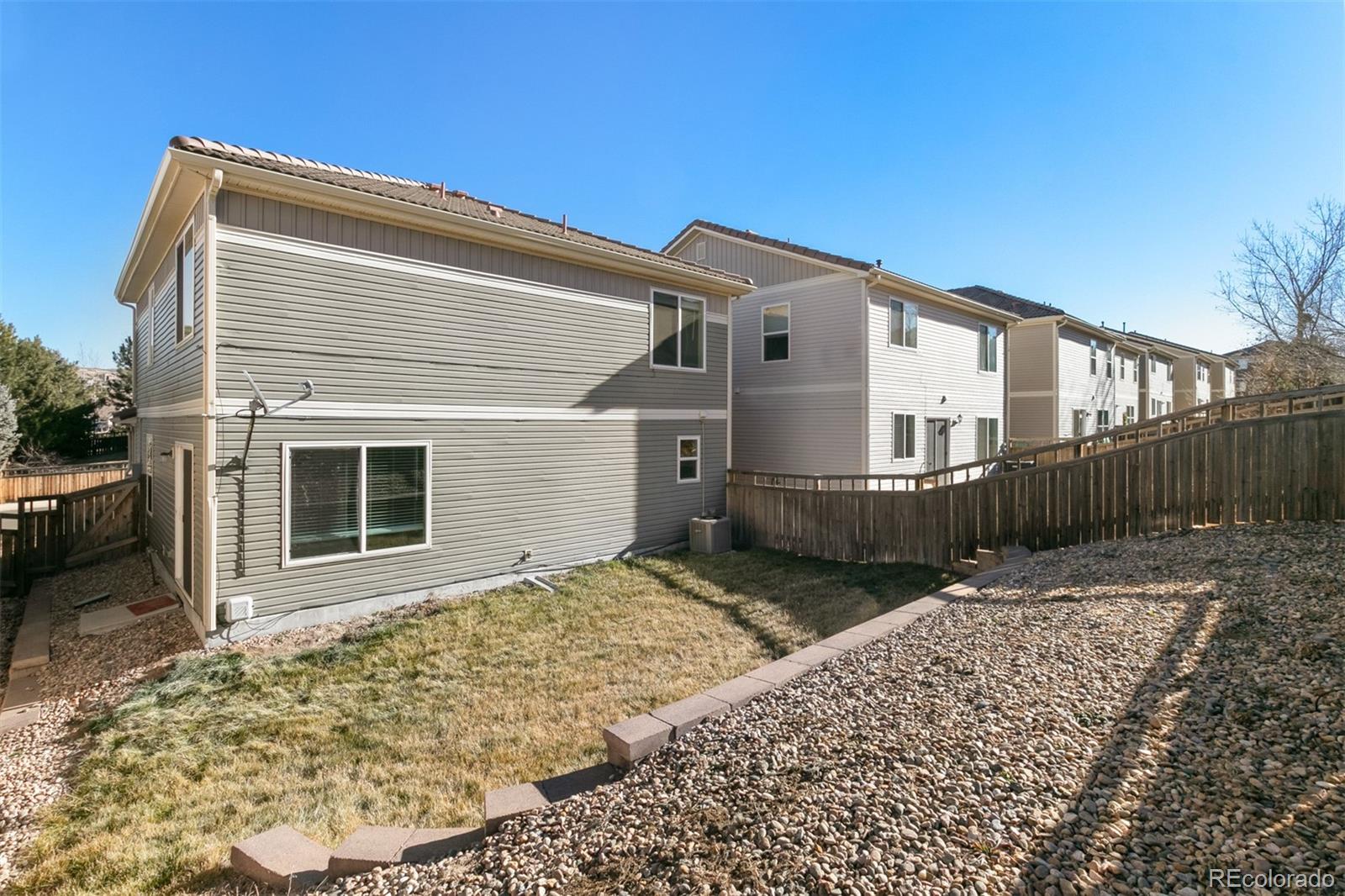 2562 Coach House Loop Castle Rock, CO 80109 - Photo 16 of 20 a view of a house with wooden fence