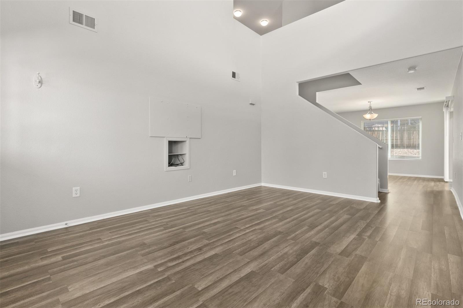 2562 Coach House Loop Castle Rock, CO 80109 - Photo 3 of 20 a view of an empty room with wooden floor