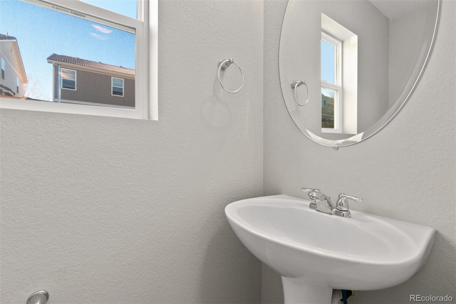 2562 Coach House Loop Castle Rock, CO 80109 - Photo 9 of 20 a bathroom with a sink and a mirror