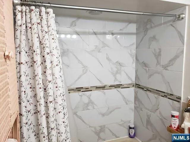 a bathroom with a shower and a shower curtain
