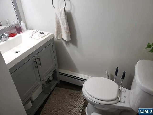 a bathroom with a sink toilet and mirror