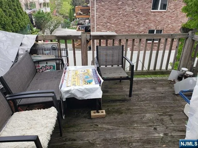 a view of balcony with wooden floor and outdoor seating