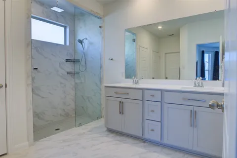 a bathroom with a shower sink and mirror