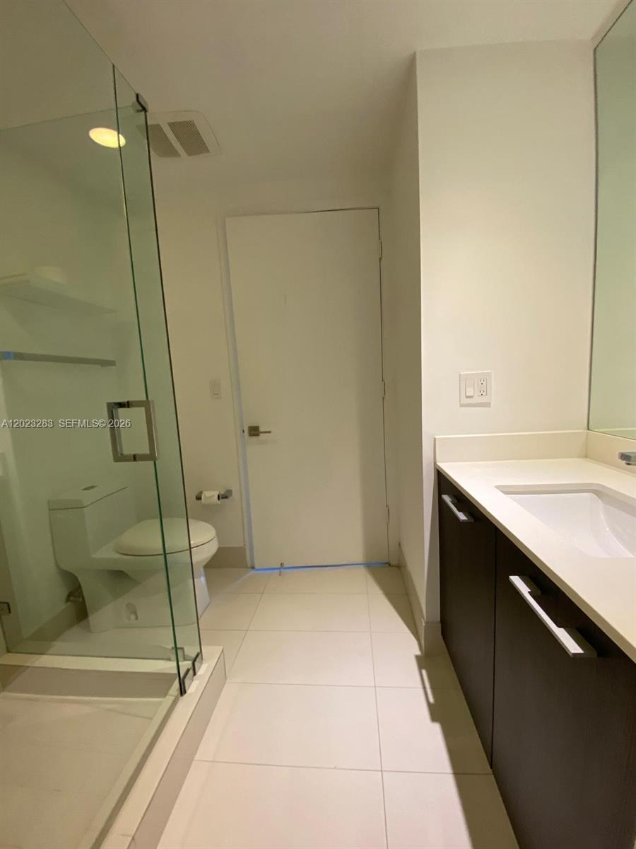 55 Southwest 9th Street, Unit 1503 Miami, FL 33130 - Photo 5 of 11 a bathroom with a sink and a shower