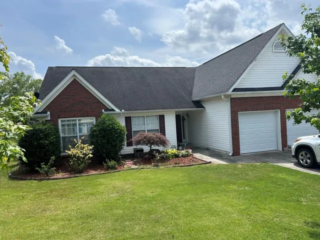 a front view of house with yard and outdoor seating
