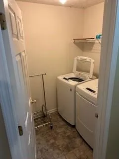 a view of storage and utility room with washer and dryer