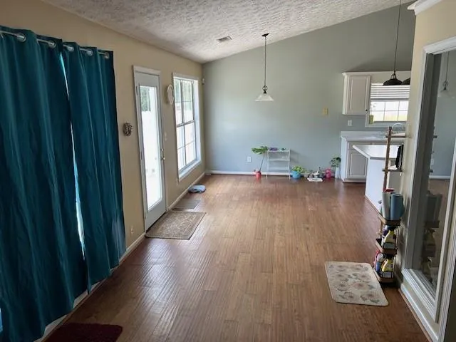 a hallway with furniture and wooden floor
