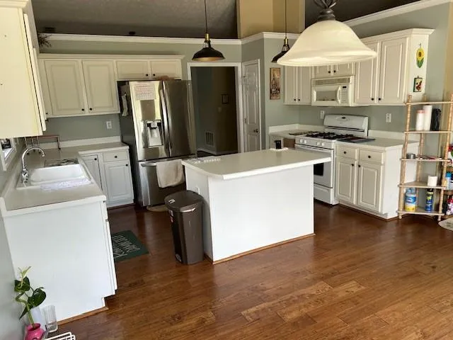 a kitchen with cabinets and wooden floors