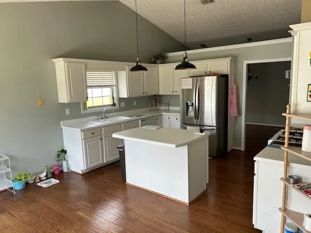 a kitchen with a sink appliances and cabinets