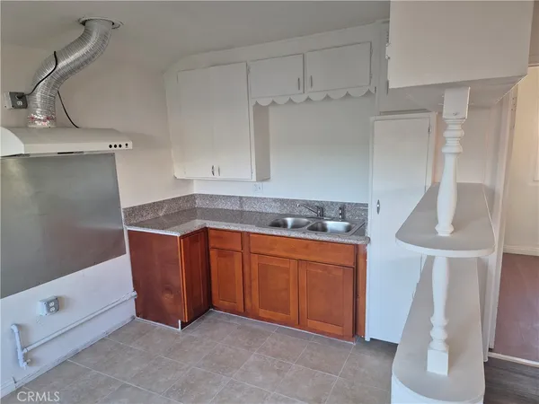 a kitchen with stainless steel appliances granite countertop a sink and a refrigerator