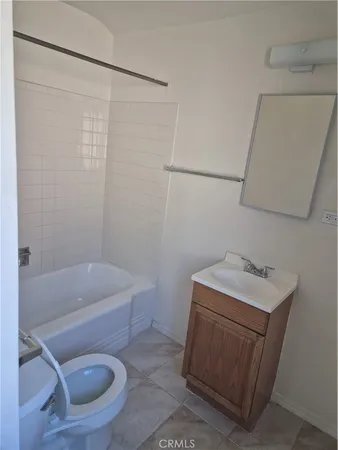 a bathroom with a sink a toilet and bathtub