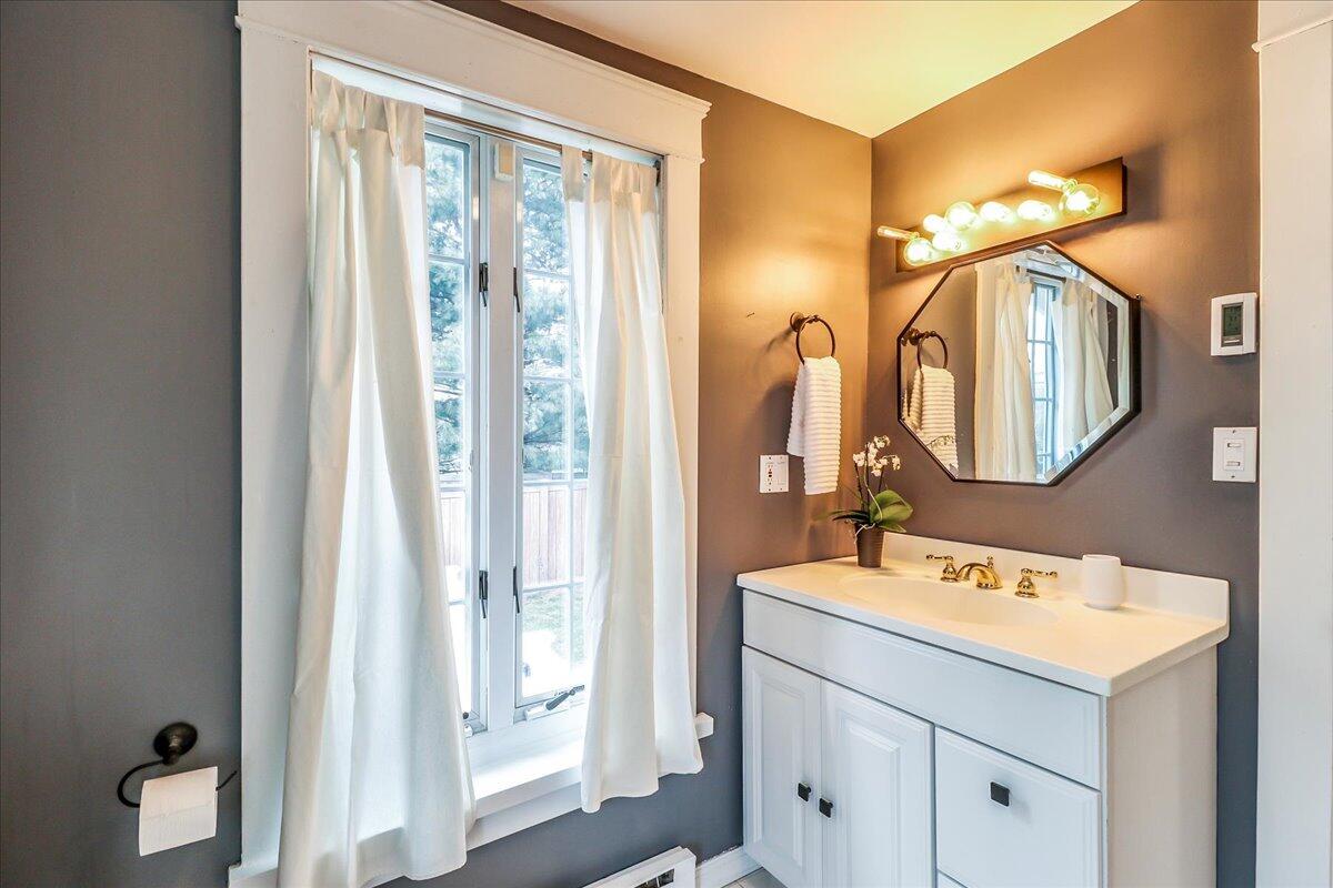 212 West Avenue Darien, CT 06820 - Photo 21 of 40 a bathroom with a sink and a mirror