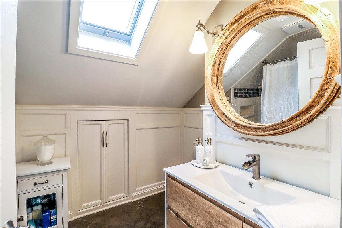 212 West Avenue Darien, CT 06820 - Photo 30 of 40 a bathroom with a sink a mirror and a toilet