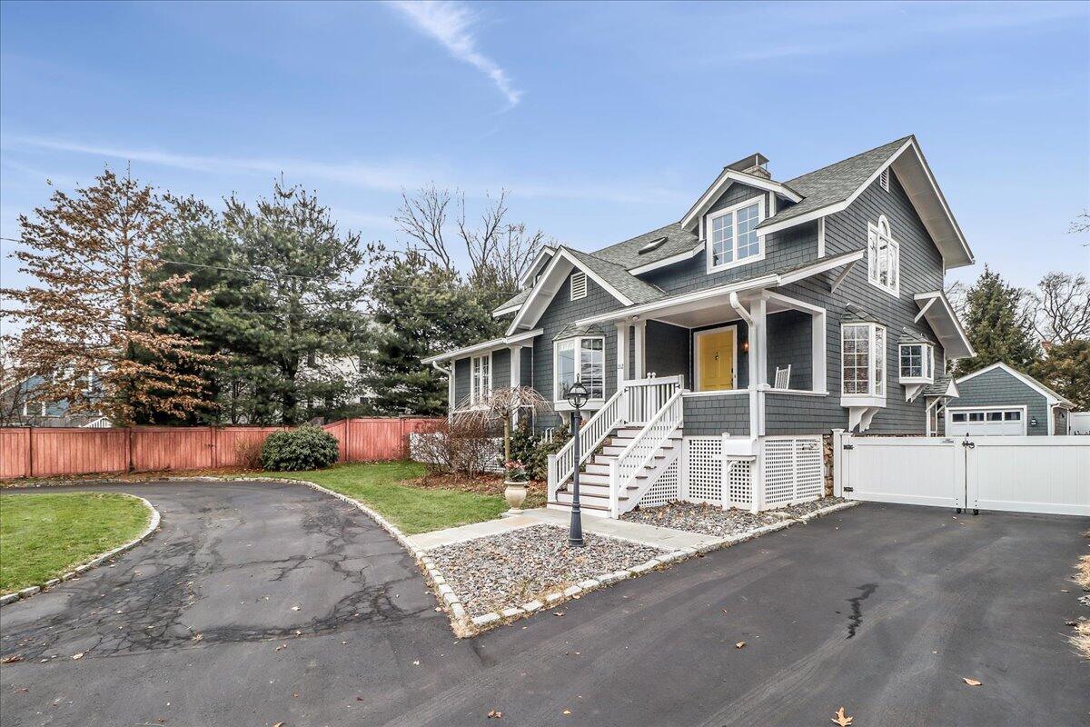 212 West Avenue Darien, CT 06820 - Photo 36 of 40 a front view of a house with a yard and garage