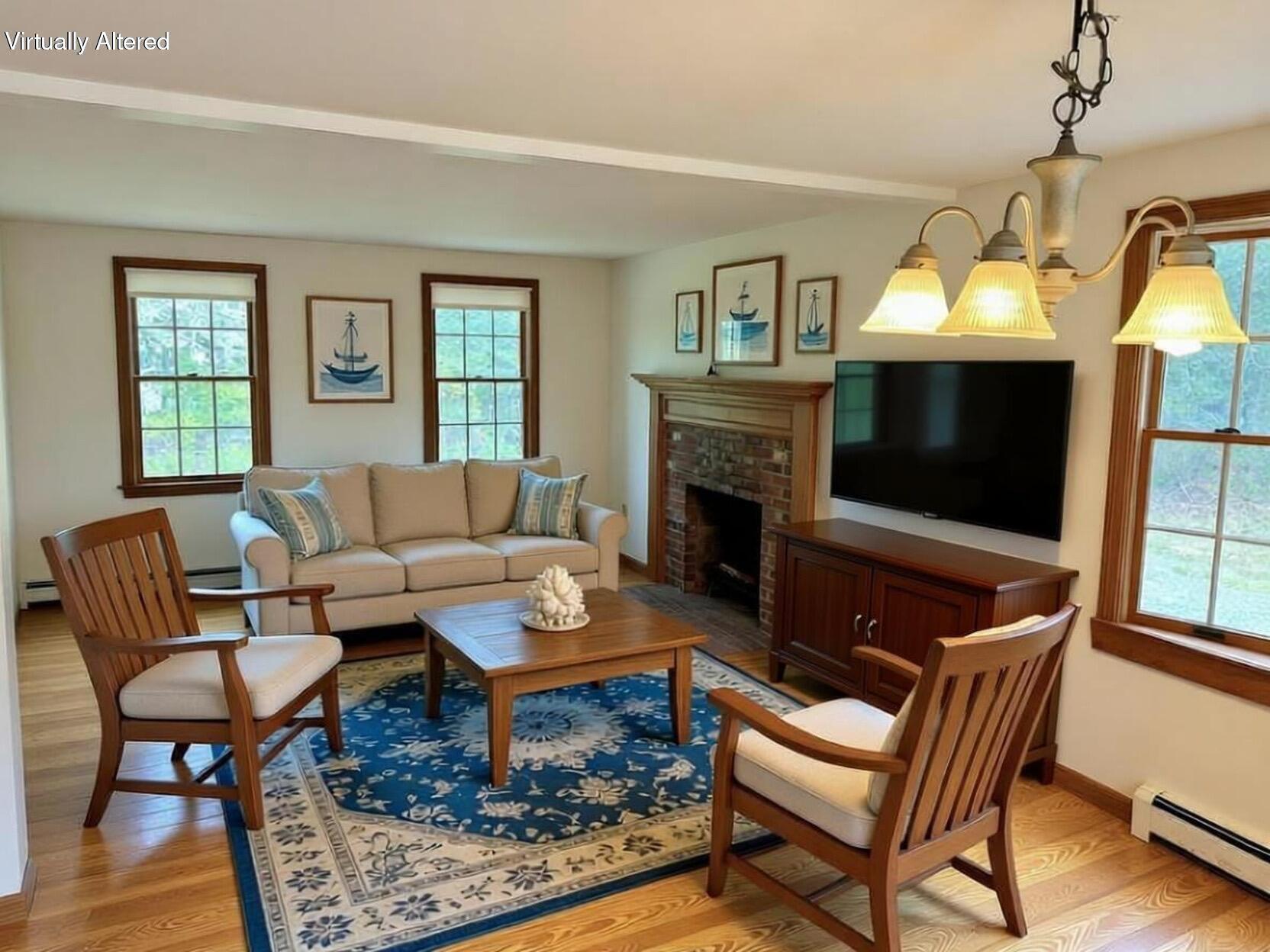 255 Massasoit Road Eastham, MA 02642 - Photo 12 of 25 a living room with furniture a fireplace and a flat screen tv
